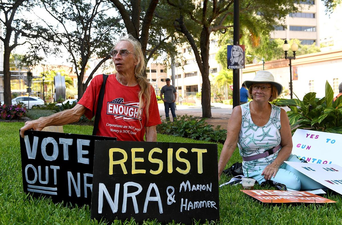Chris Rouse and Liz Winegrad wait to see Gabby Giffords, former Arizona congresswoman and gun control advocate after being a victim of gun violence, address a group at Sarasota's Five Points Park Thursday.