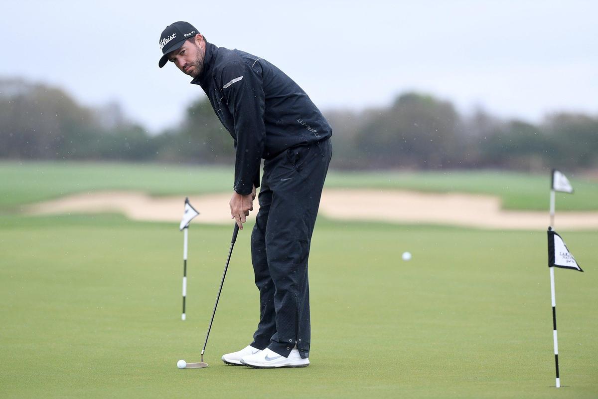 Seath Lauer practices on a putting green Wednesday morning in the rain for the Web.com Tour at Lakewood National Golf Club.