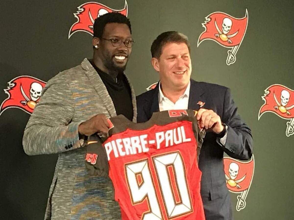In this March 23, 2018, file photo, Buccaneers NFL football player Jason Pierre-Paul, left, poses with team general manager Jason Licht during a news conference in Tampa, Fla. The Bucs addressed pressing needs to improve an anemic pass rush and bolster depth on the defensive line by trading for Jason Pierre-Paul and signing Beau Allen and Vinny Curry in free agency.