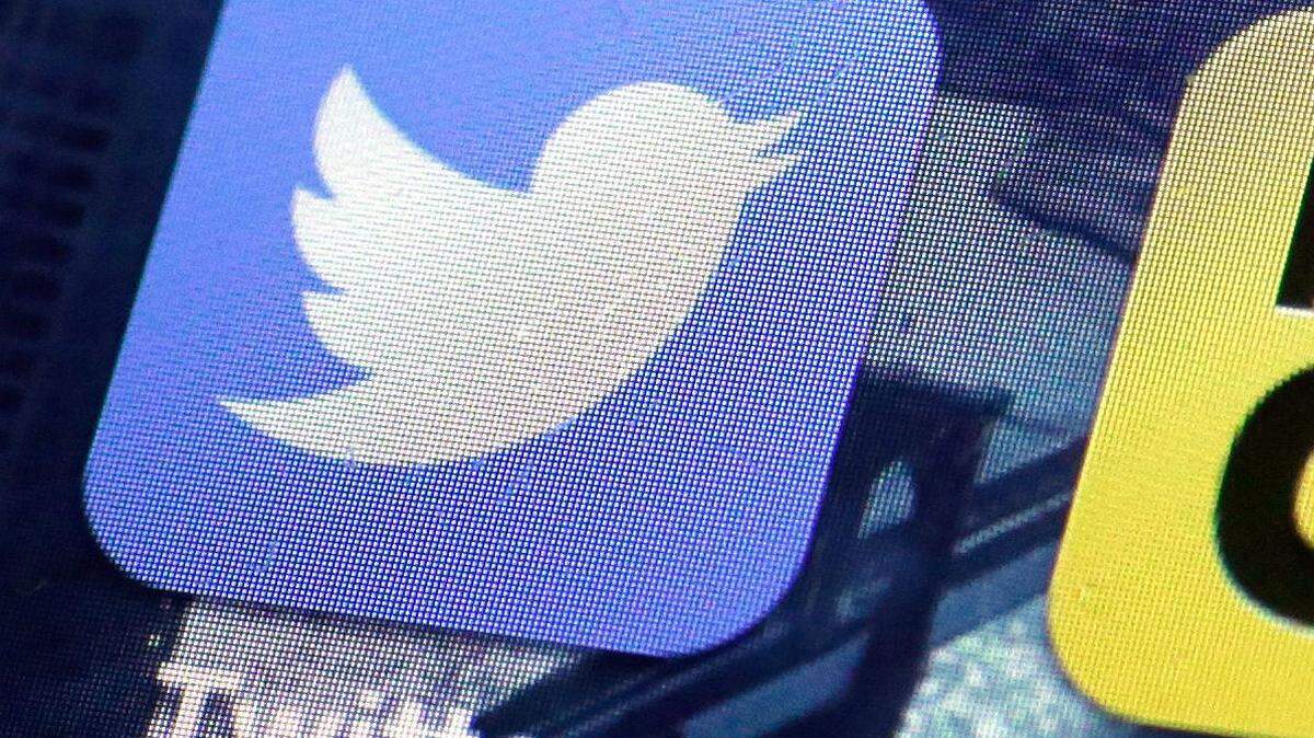 FILE - This Friday, Oct. 18, 2013, file photo, shows a Twitter app on an iPhone screen, in New York. Twitter announced, Tuesday, Oct. 13, 2015, the company is laying off 336 employees, signaling CEO Jack Dorsey's resolve to slash costs while the company struggles to make money. (AP Photo/Richard Drew, File)
