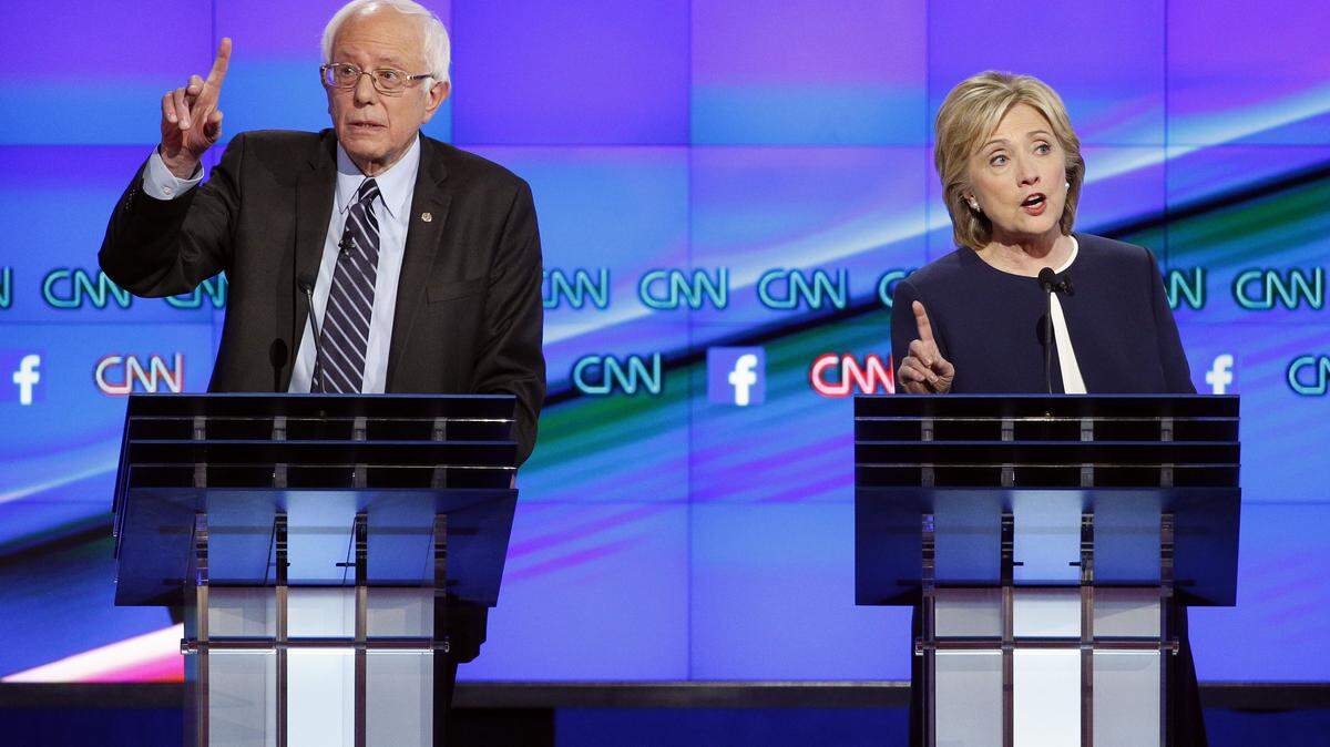 Hillary Rodham Clinton, right, and Sen. Bernie Sanders, of Vermont, speak during the CNN Democratic presidential debate Tuesday, Oct. 13, 2015, in Las Vegas. (AP Photo/John Locher)