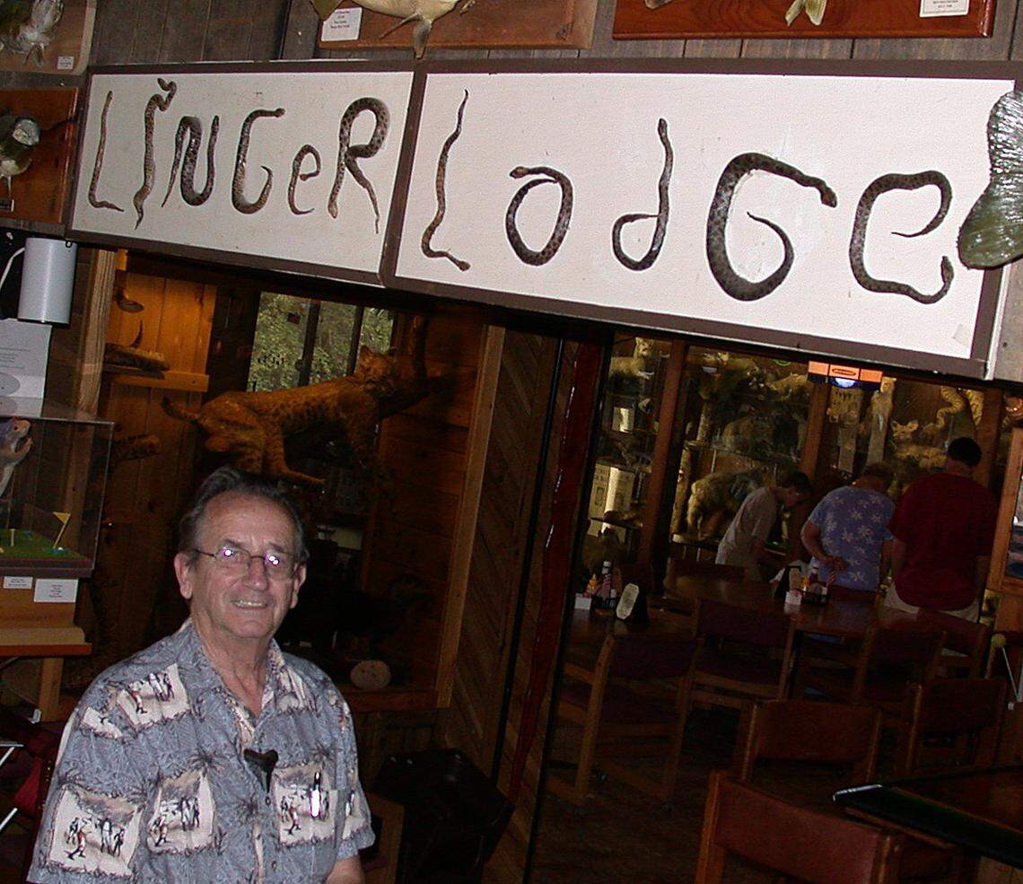 Frank Gamsky stands next to snake sign in 2002.