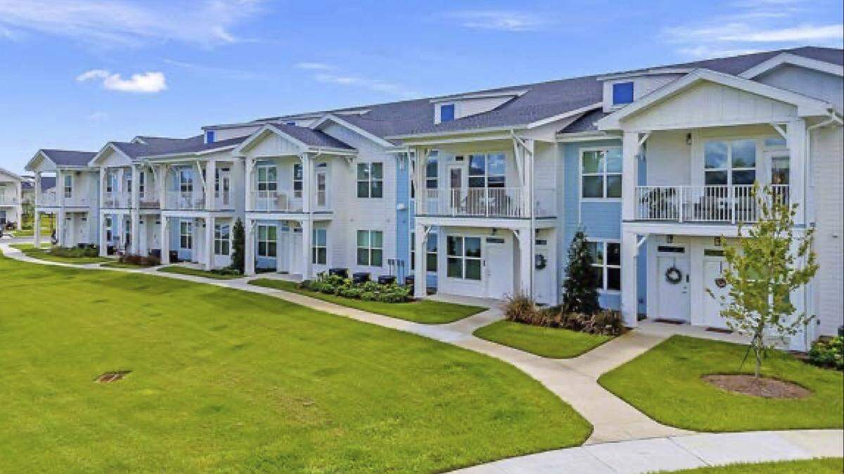 A photo shows one of Penler’s multifamily developments of similar construction to the one proposed along Lorraine Road.