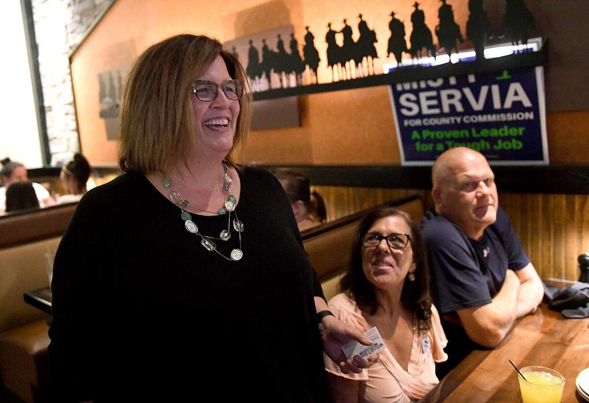 Misty Servia smiles with friends and family as she awaits election results Tuesday night at the Longhorn Steakhouse in Bradenton.