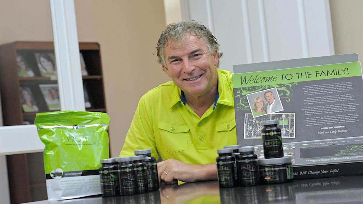 Mark Pentecost, president and chief executive officer of It Works! Global, with some of the direct sales company's product line of health and beauty products. PAUL VIDELA/Bradenton Herald