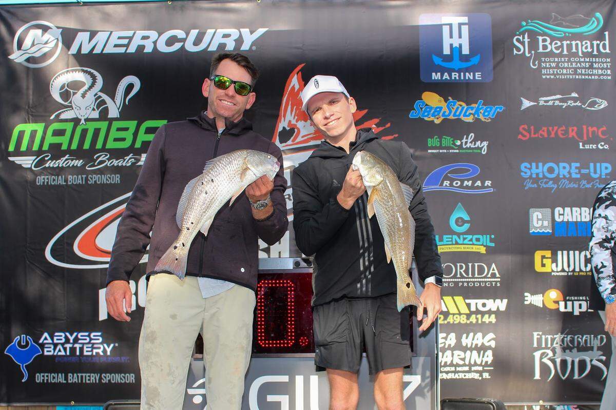 Cody Chivas with his brother and a redfish at a tournament in December 2022.