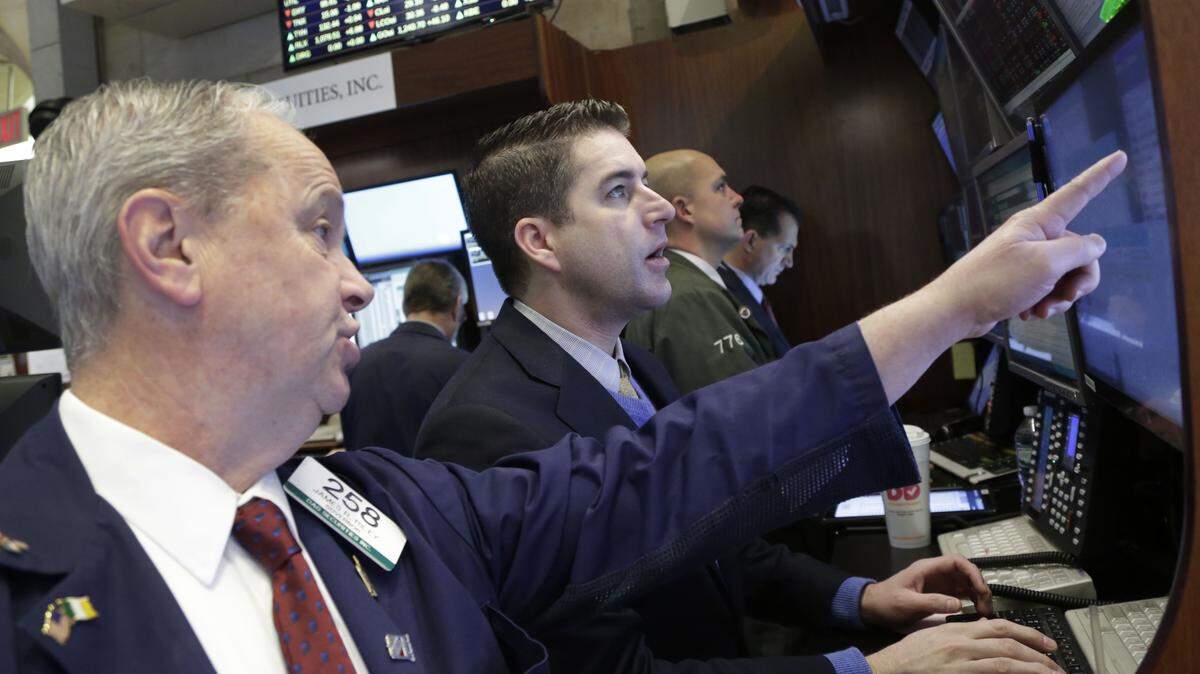 James Riley, left, and Dennis Ulikowski Jr. watch stock prices at the New York Stock Exchange, Thursday, Feb. 11, 2016, in New York. (AP Photo/Mark Lennihan)