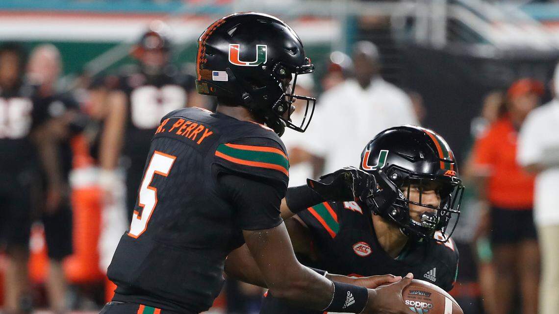 Miami quarterback N’Kosi Perry (5) hands off to running back Travis Homer (24) during the first half of an NCAA college football game against North Carolina, Thursday, Sept. 27, 2018, in Miami Gardens, Fla.
