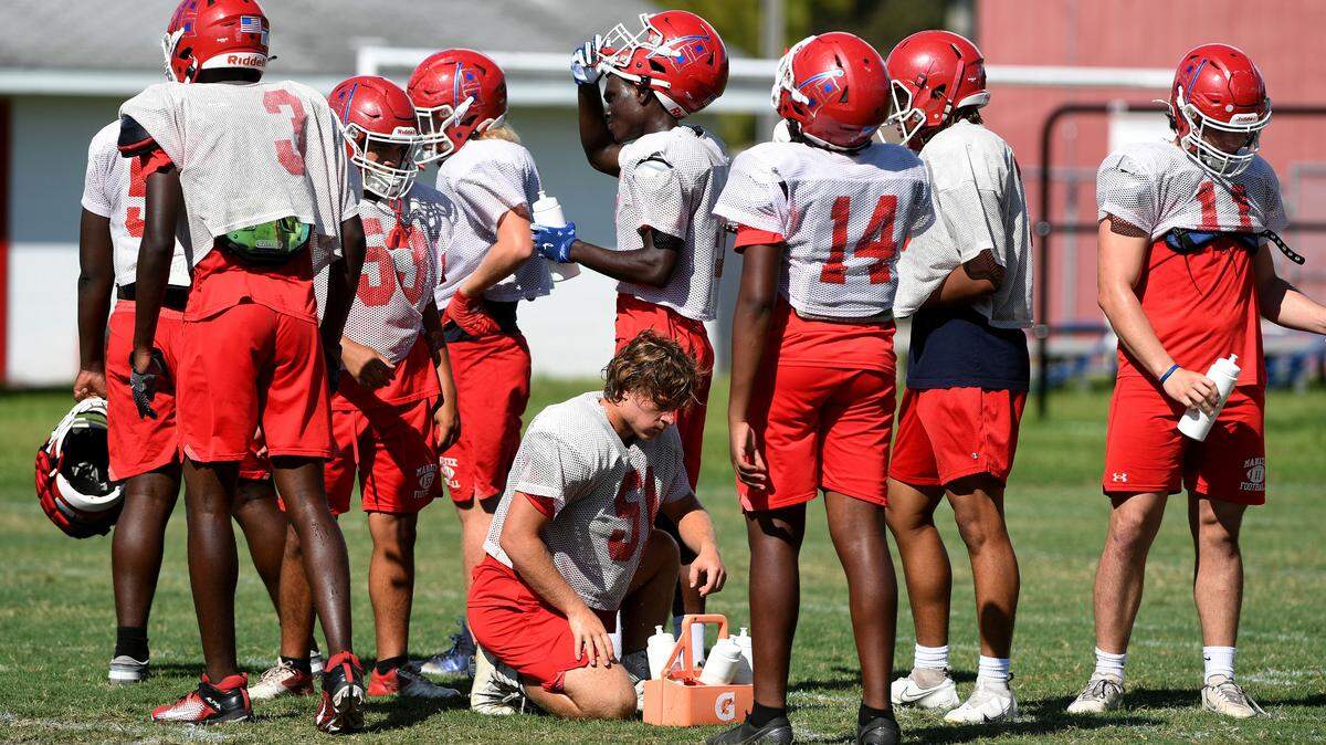 Manatee High football players take a water break during practice at on Wednesday, Sept. 21, 2022.