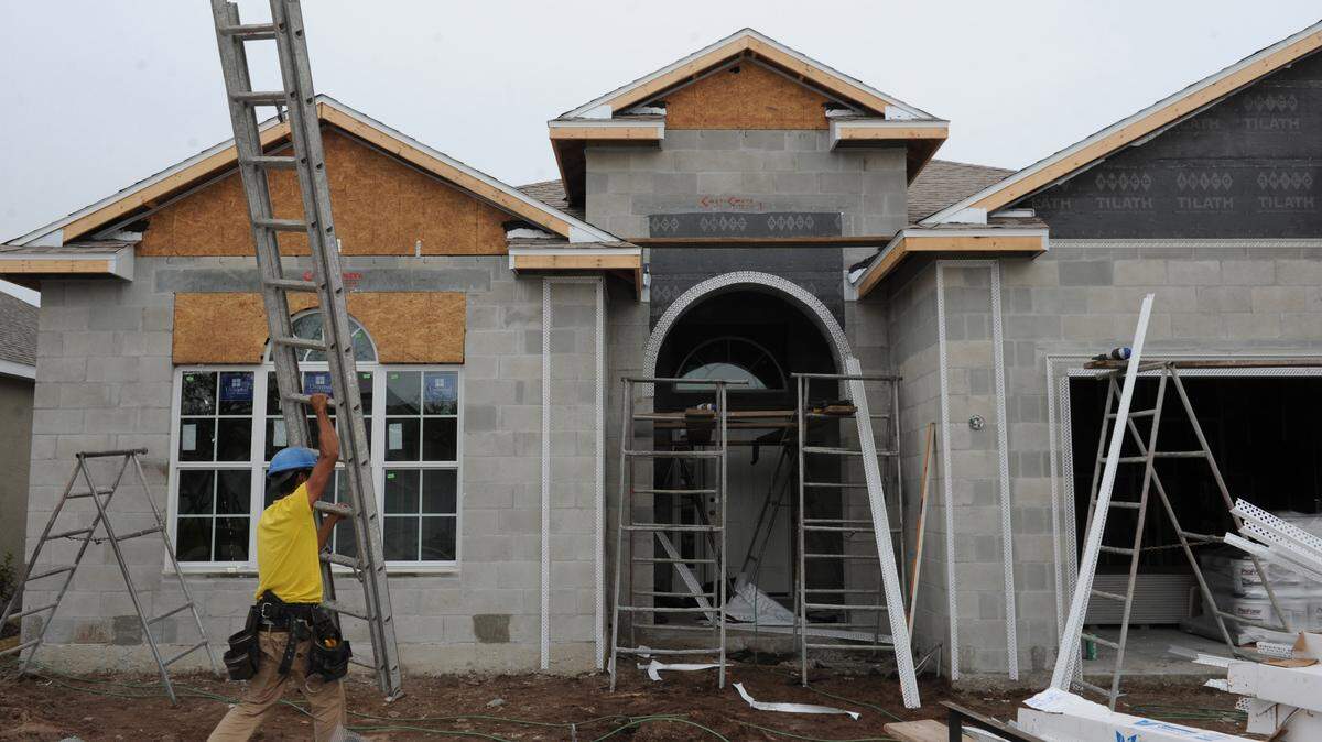Workers construct a home in Central Park, a community adjacent to Gullett Elementary School one of the county's newest schools in Lakewood Ranch. The Manatee County School District is planning to work with the county to study the possibility of reinstating impact fees on new homes built in the district.GRANT JEFFERIES/Bradenton Herald