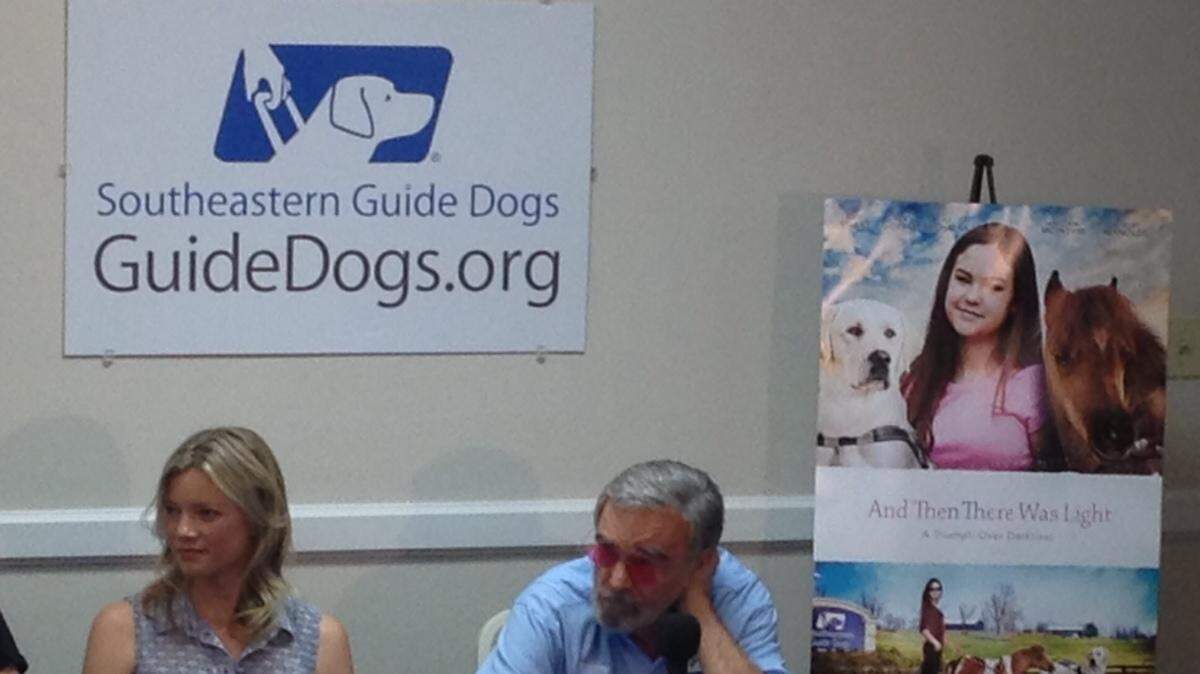 Actors Amy Smart and Burt Reynolds appear at a news conference Wednesday at Southeastern Guide Dogs in Palmetto.