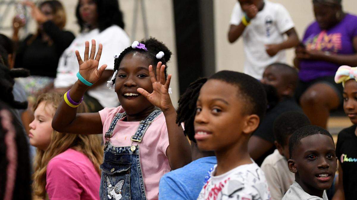 Children respond to author Vincent Taylor Friday at the 13th Av Center during a presentation encouraging audience participation. The Rosalyn Walton Education and Enrichment Services, Inc along with the 13th Avenue Dream Center is hosting the 6th Annual Juneteenth Reading Conference and Community Festival which continues Saturday.