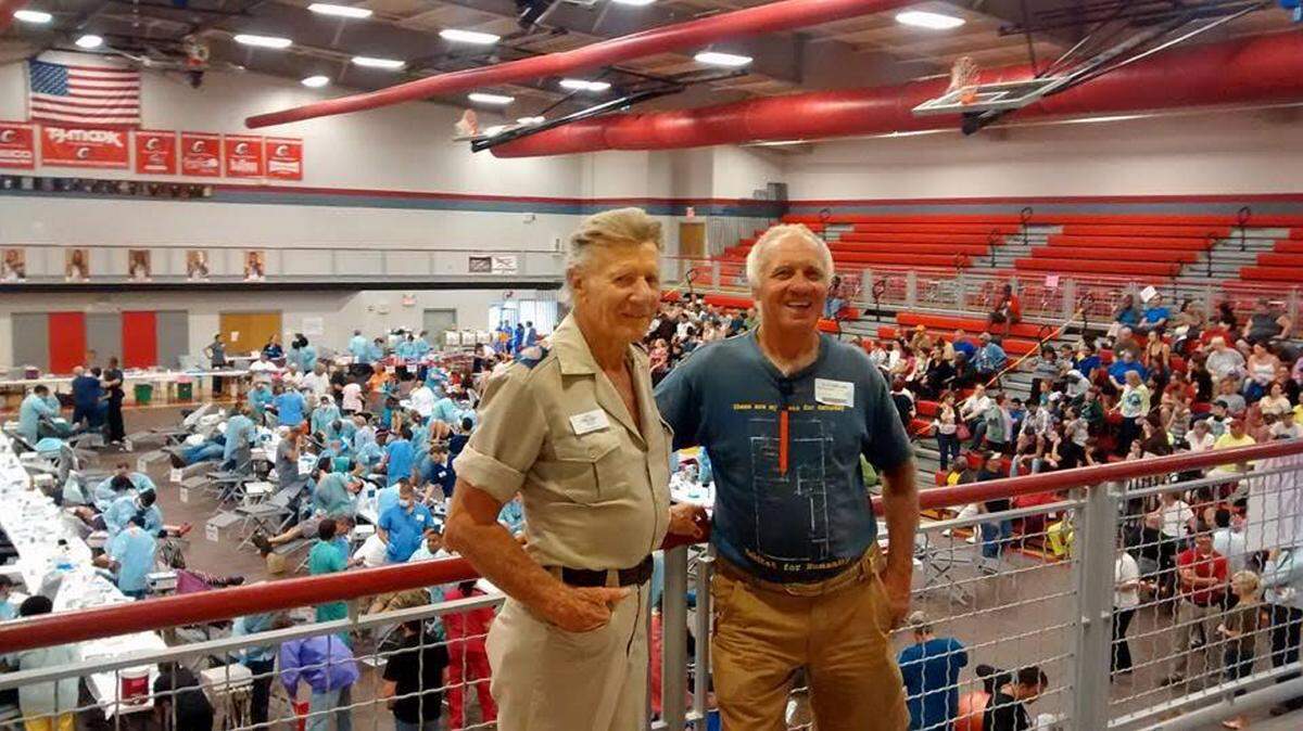 Stan Brock, left, founder and president of Remote Area Medical USA, and Bradenton's Glen Gibellina, stand above the basketball court at Ooltewah High School in Ooltewah, Tenn., where a free RAM medical clinic was held in September. PROVIDED PHOTO