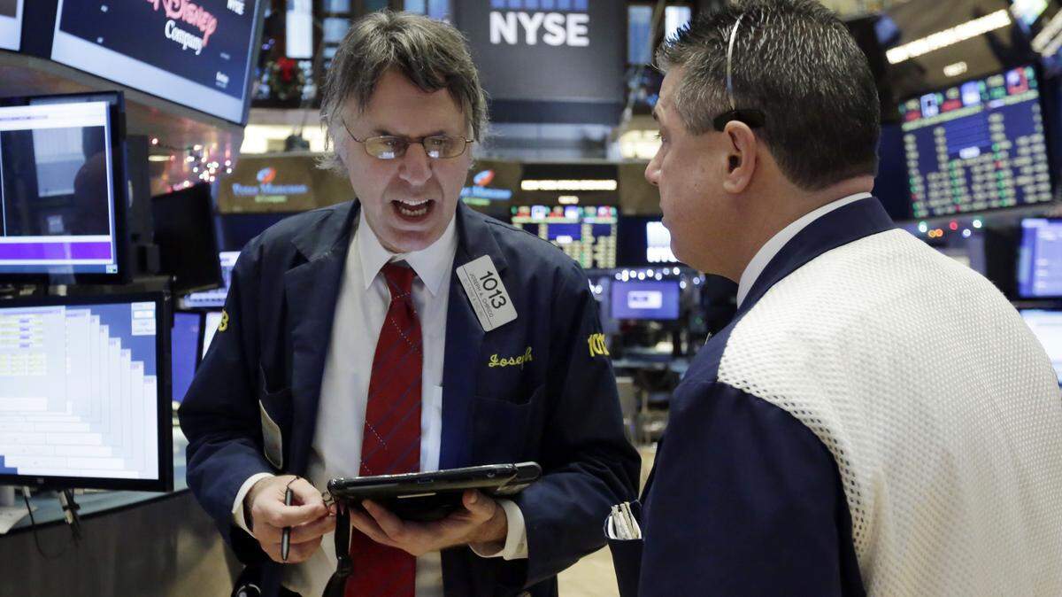 Joseph Chirico, left, talks with a fellow trader on the floor of the New York Stock Exchange, Tuesday, Dec. 15, 2015. Stocks are climbing in early trading as buyers return to a market that has been mostly beaten down in recent days. (AP Photo/Richard Drew)