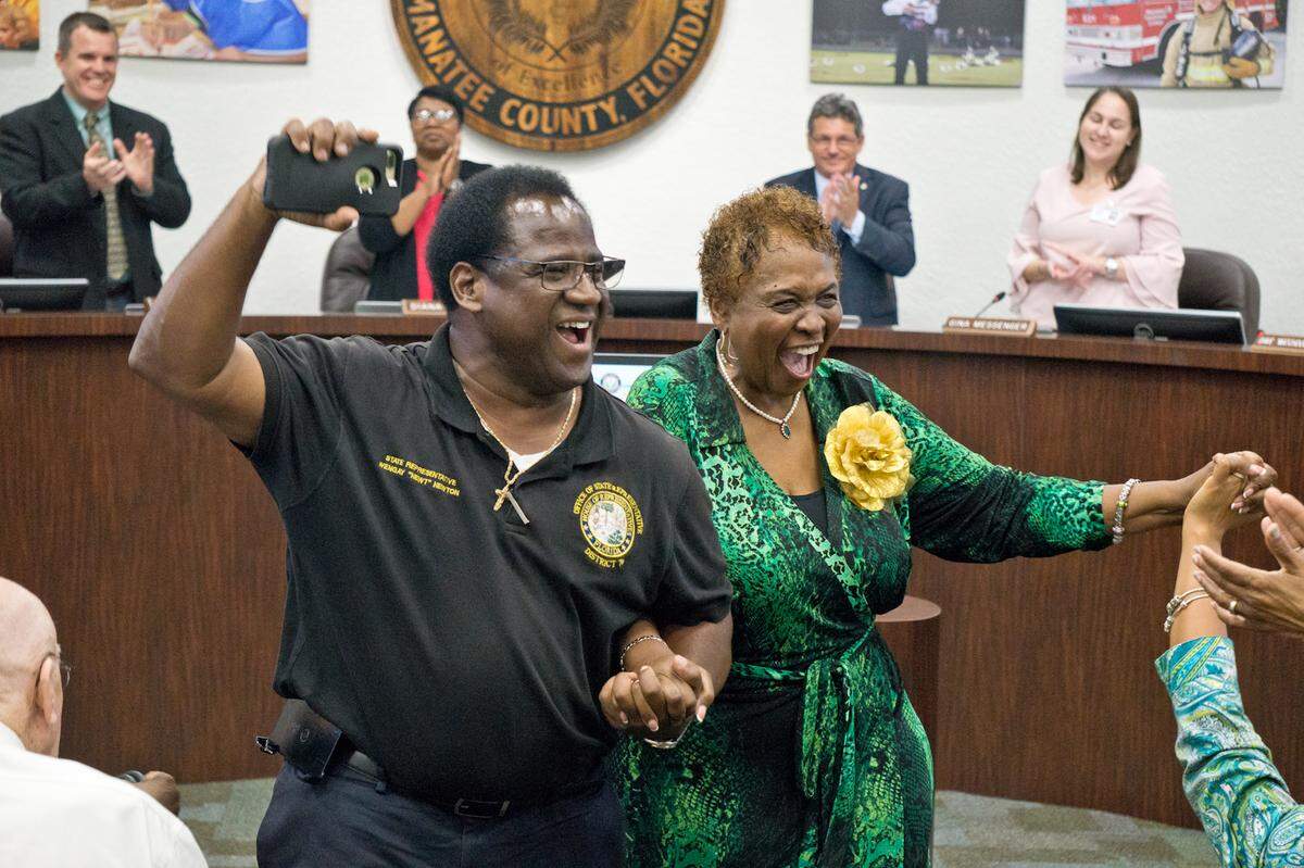 State Rep. Wengay Newton, left, celebrates alongside Barbara Harvey after the School Board of Manatee County unanimously voted to name a new school in her honor.