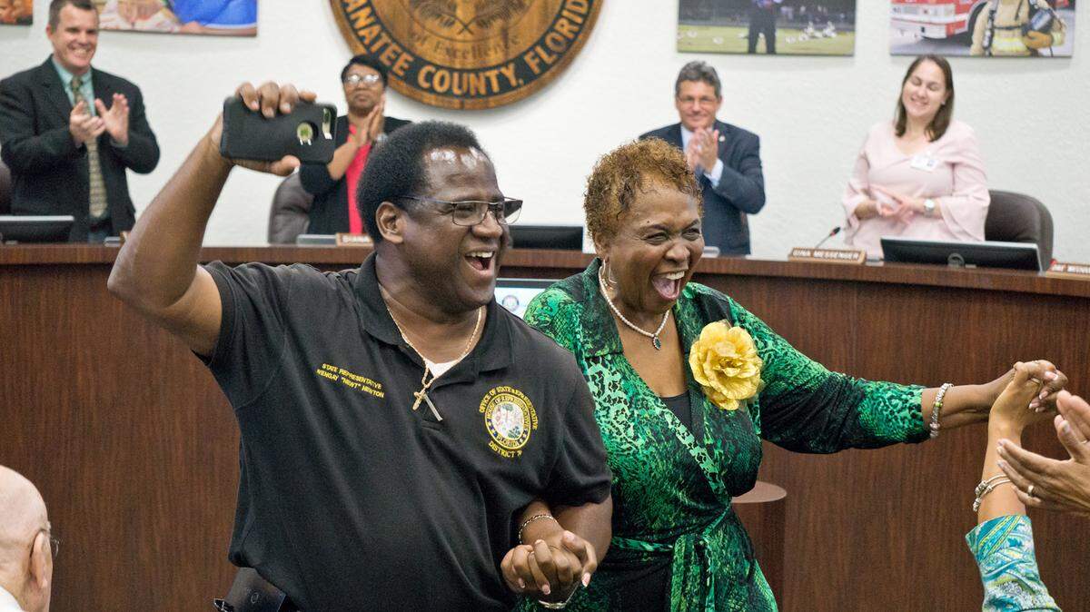 State Rep. Wengay Newton, left, celebrates alongside Barbara Harvey after the School Board of Manatee County unanimously voted to name a new school in her honor.