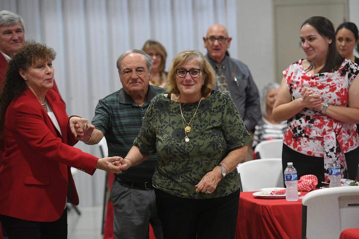 Popi and Manny Ameres, founders of Popi’s restaurants in Bradenton-Sarasota area, walk to the stage after their names were announced as the Manatee County Fair’s distinguished citizens on Jan. 5, 2023.