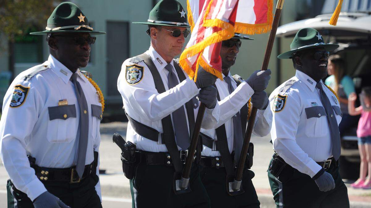Members of the Manatee County Sheriff's Office honor guard lead the Martin Luther King Jr. parade Saturday in Palmetto. 
 GRANT JEFFERIES/Bradenton Herald