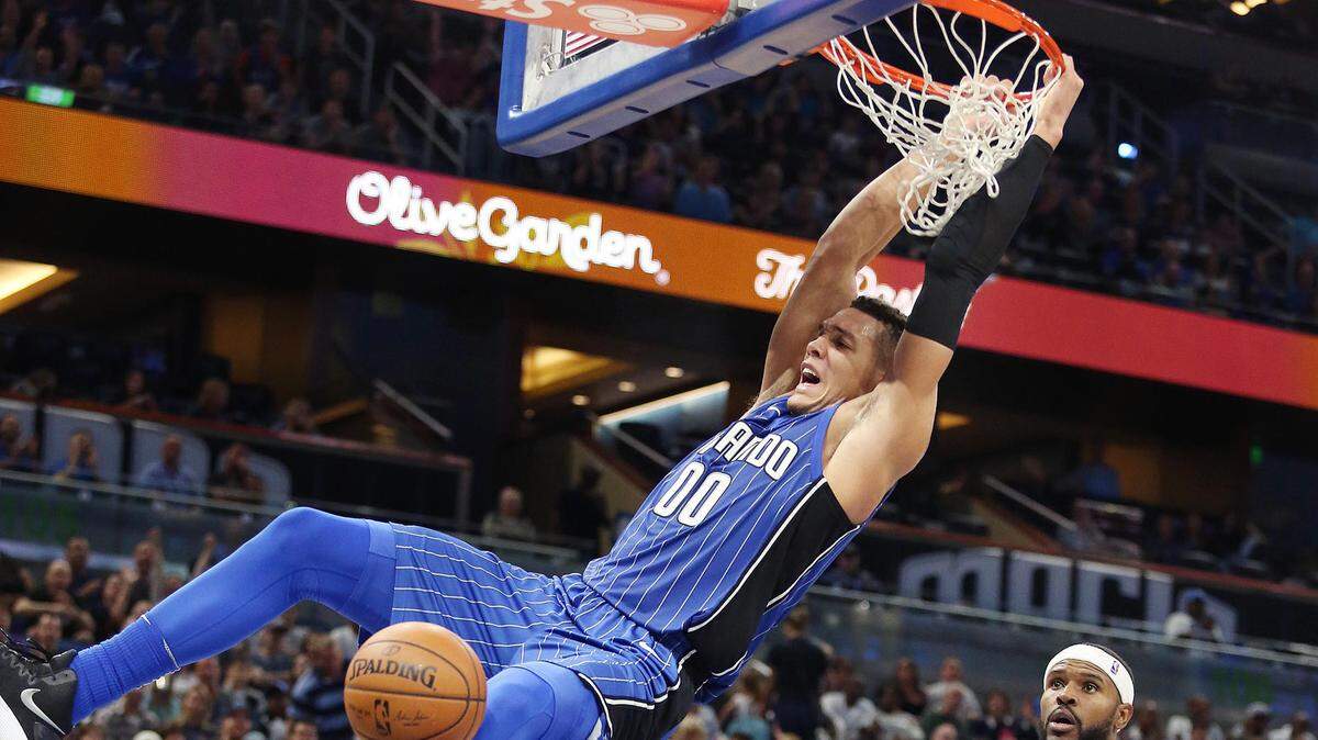 Orlando Magic forward Aaron Gordon has agreed to a four-year deal worth about $84 million to stay with the Magic. He is pictured here as he slam dunks over Brooklyn Nets forward Trevor Booker (35) at the Amway Center on Tuesday, October 24, 2017.