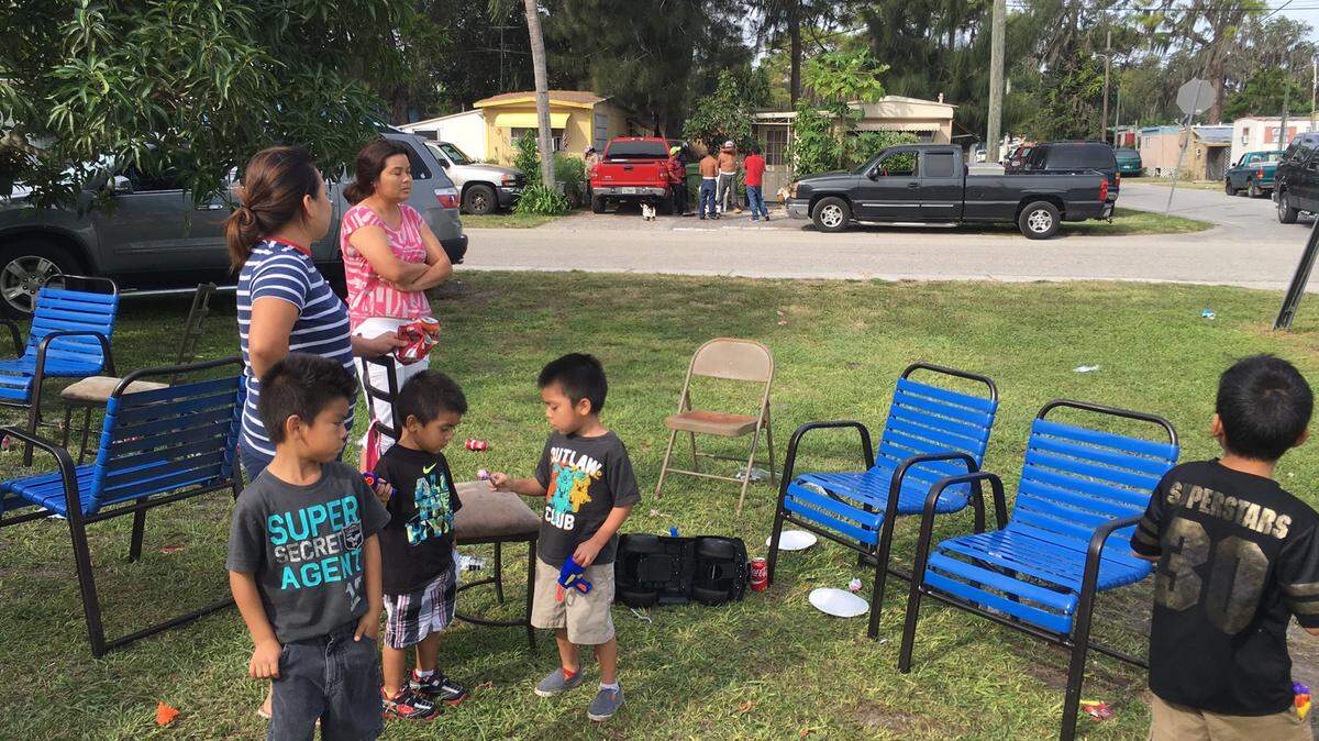 Esbeyda Agustin, left, her mother and children live across the street from where a fatal shooting occurred Saturday on the corner of 23rd Street East and Sixth Avenue Drive East in East Bradenton. 
 RICHARD DYMOND/Bradenton Herald