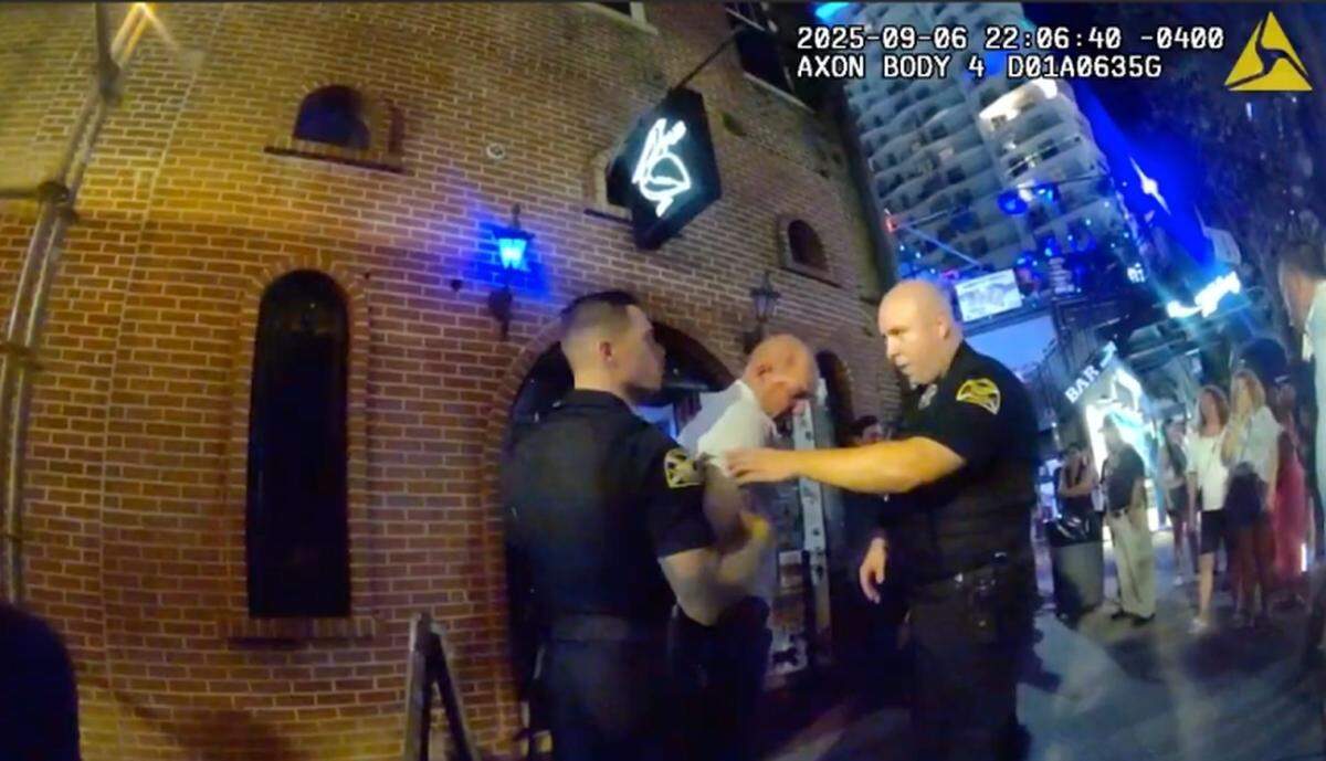 Manatee County Sheriff’s Lt. Randall Crawford (middle) being detained by St. Petersburg police officers outside a nightclub on Sept. 6.