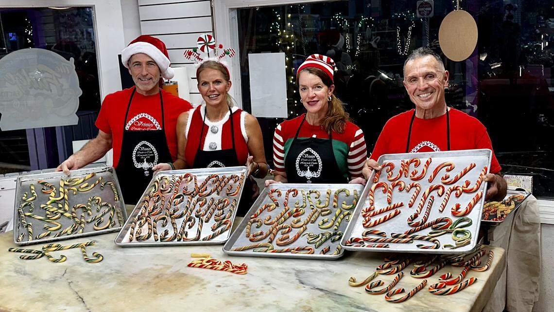 Ted Berg, Melissa Keirns Delaney, Tamela Behm-Vrinios and Peter Vrinios display the candy canes made atop the Vrinios family’s antique candy table at the Fudge Factory in Bradenton Beach. Vrinios’ family has been making candy for four generations and has been putting on a candy show during the holidays.