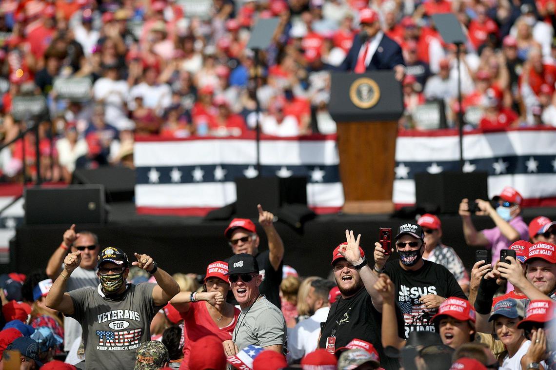 Angry people chant ‘fake news’ as President Trump holds a rally in a parking lot at Raymond James Stadium in Tampa October 29.
