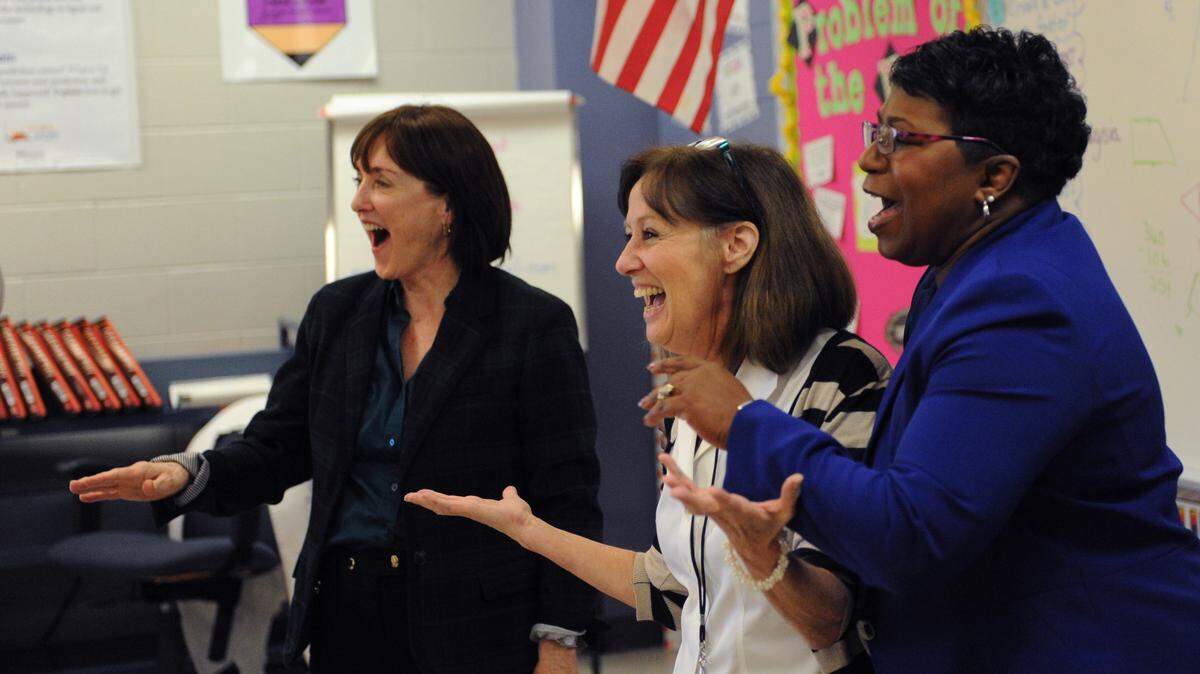 Mary Glass, Manatee Education Foundation executive director, Nolan Middle School math teacher Mary Anne Maginot and Manatee School Superintendent Diana Greene laugh Friday when students request postponement of a math test after Maginot was named a finalist for Educator of the Year.GRANT JEFFERIES/Bradenton Herald