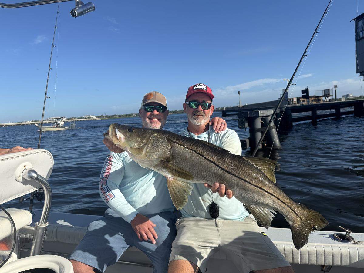 Captain Josh Prunier and angler Zach McDonald pose with a 41-inch snook caught during the 28th annual Fishing Funds the Cure tournament.