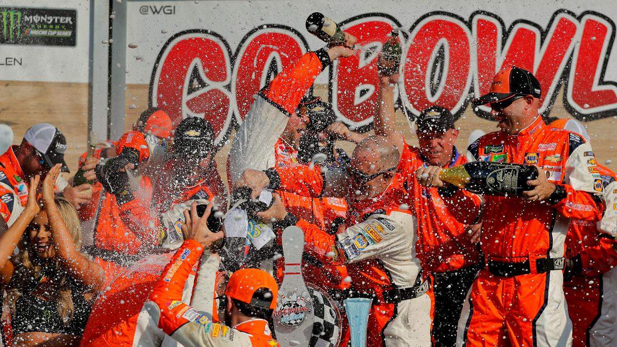 Chase Elliott and his pit crew celebrate after winning a NASCAR Cup Series auto race, Sunday, Aug. 5, 2018, in Watkins Glen, N.Y.