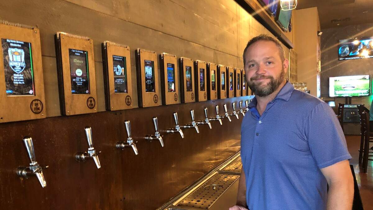 Brett Decklever, co-founder of Oak & Stone, stands along the tap wall at the company’s new Fastfire restaurant at 6220 14th Street W., Bradenton.