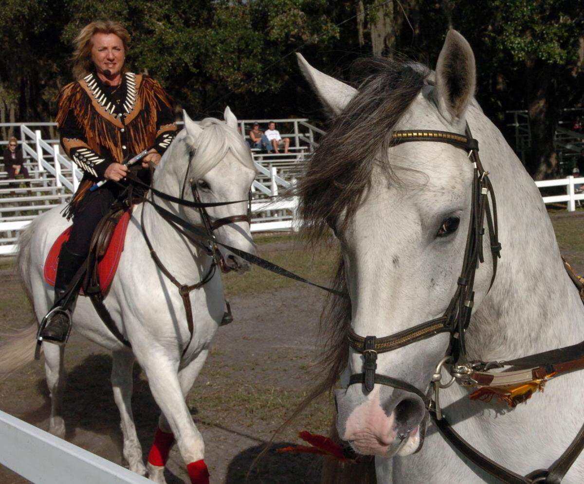 11/6/2018--Gabriella Herrmann demonstrates riding with horses in tandem during a winter training session at the family stables.