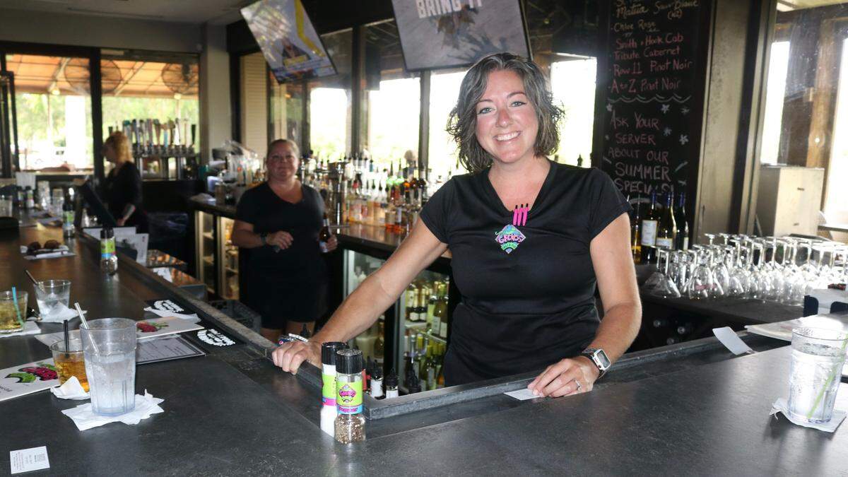 Arrica Dallas, shown 05/26/2021, has tended bar at Gecko’s Grill & Pub for eight years and said she enjoys her regulars and the support and encouragement of management.