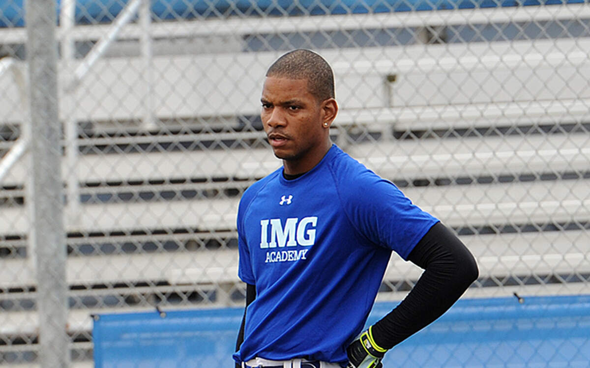 Former West Indies cricket player Kieren Powell, white pants, participates in a Major League Baseball workout at IMG Academy. 
 TIFFANY TOMPKINS-CONDIE/Bradenton Herald