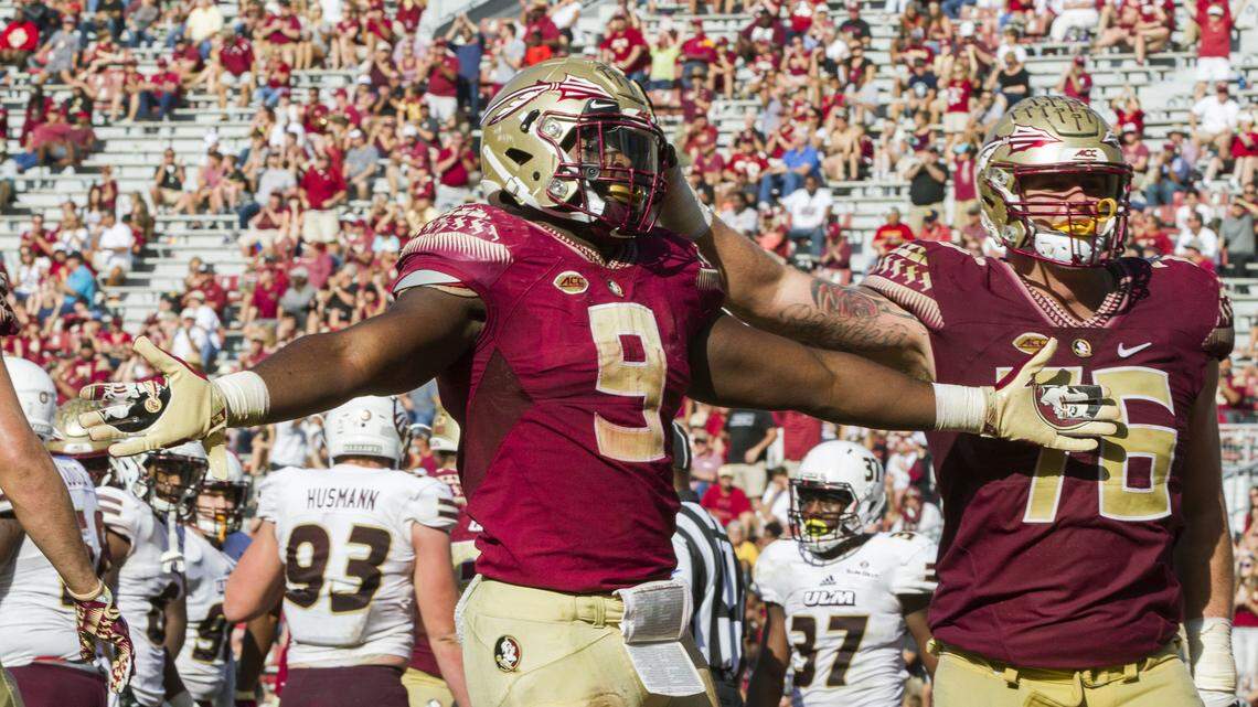 Florida State running back Jacques Patrick (9) and offensive lineman Rick Leonard celebrate Patrick's touchdown in the second half of an NCAA college football game against Louisiana Monroe in Tallahassee on Saturday, Dec. 2, 2017.