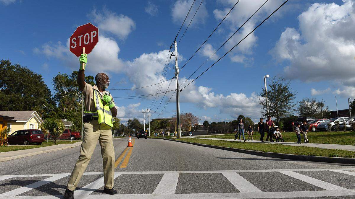 Jerry Nelson has spent five years as a crossing guard for the city of Bradenton, ensuring the safety of students who walk to and from G.D. Rogers Garden Elementary School. The Manatee County School District is hoping the state will provide waivers to some children who miss school because the walk is too far or unsafe and give them the chance to ride the bus.TIFFANY TOMPKINS/Bradenton Herald