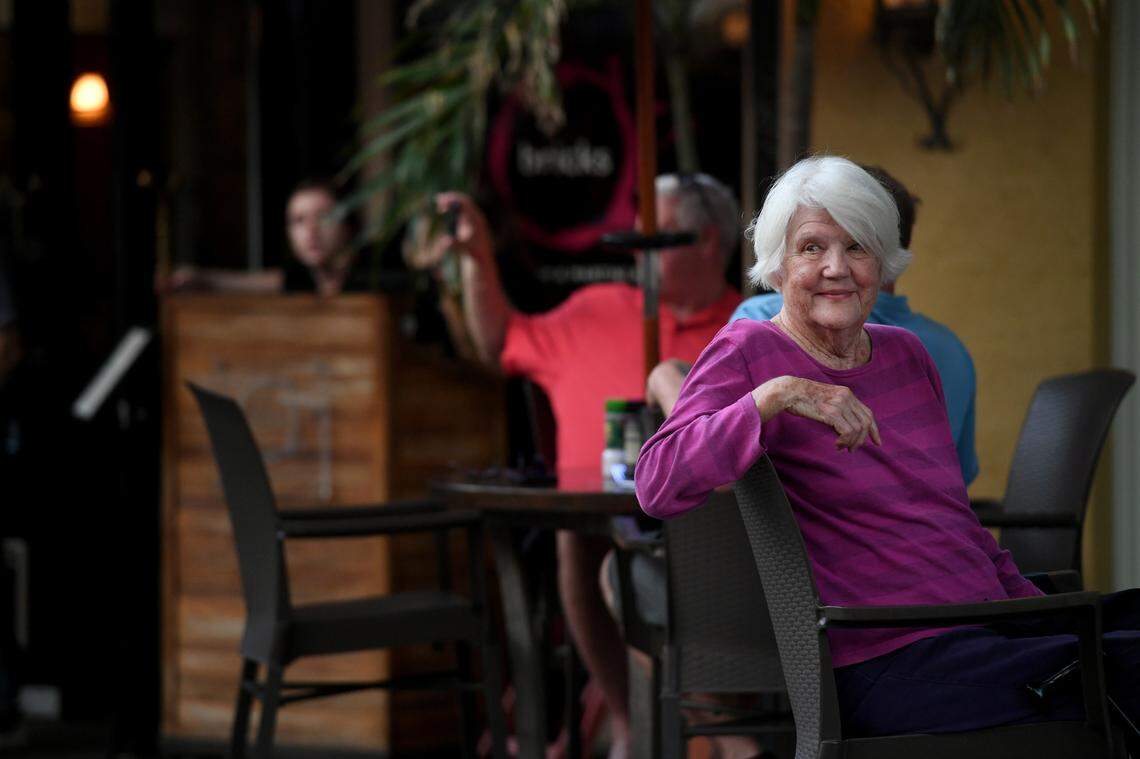 A woman eating at O’Bricks watches as over a hundred people joined a march and rally organized by Women’s Voices of SW Florida to support women’s rights to choose abortion on May 4, 2022. The group met at the Central Library and marched to the Historic Courthouse.