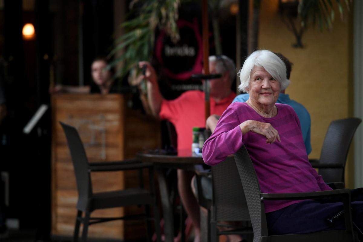 A woman eating at O’Bricks watches as over a hundred people joined a march and rally organized by Women’s Voices of SW Florida to support women’s rights to choose abortion on May 4, 2022. The group met at the Central Library and marched to the Historic Courthouse.