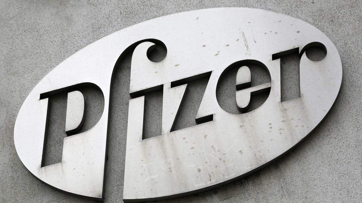 FILE - In this May 4, 2014, file photo, the Pfizer logo is displayed on the exterior of a former Pfizer factory in the Brooklyn borough of New York. Pfizer, the biggest U.S.-based drugmaker, is increasing its financial assistance to patients by doubling the allowable income level for people to receive Pfizer medicines for free. (AP Photo/Mark Lennihan, File)