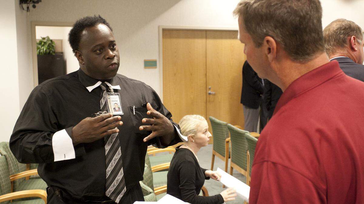 Charles Smith, a member of the Manatee County Port Authority, talks to landowner Alan Jones during the mix-and-mingle portion of Thursday's public workshop for the port's five-year master plan update. MATT M. JOHNSON/Bradenton Herald