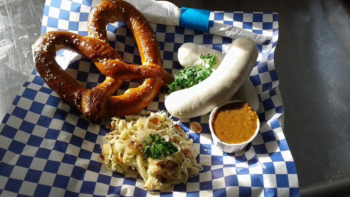 Weisswurst (minced veal and pork bacon sausage) with a pretzel and sweet mustard as served by The Schnitzel Trailer.