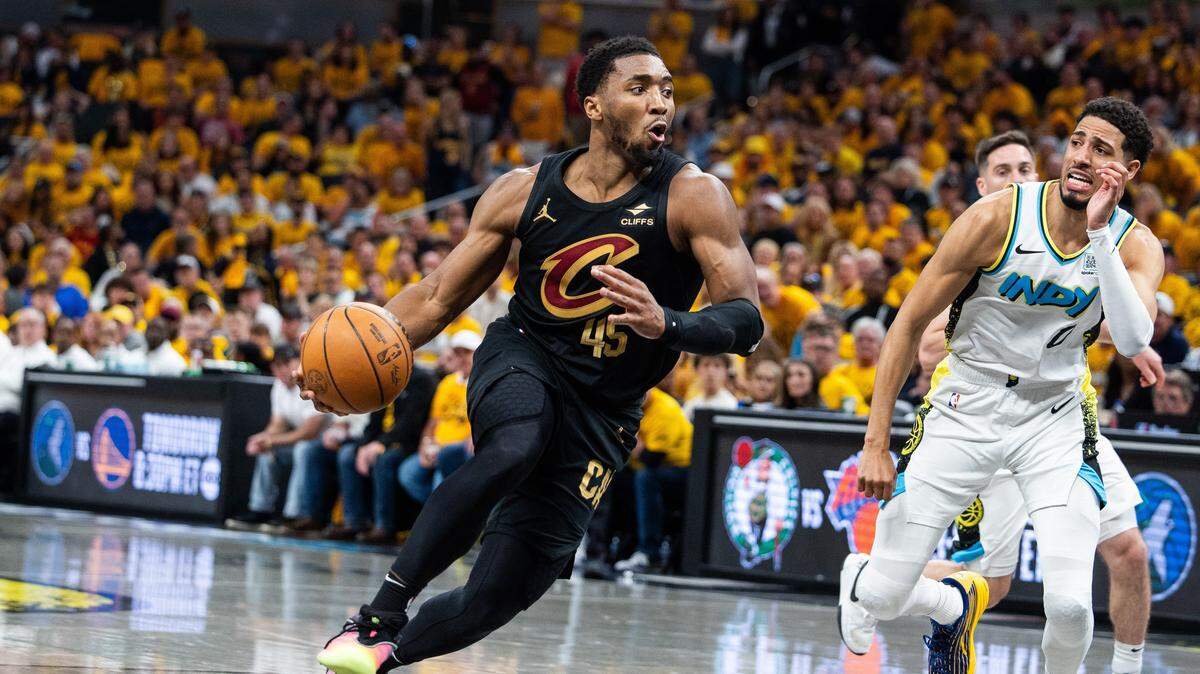 May 9, 2025; Indianapolis, Indiana, USA; Cleveland Cavaliers guard Donovan Mitchell (45) dribbles  the ball while Indiana Pacers guard Tyrese Haliburton (0) defends during game three of the second round for the 2025 NBA Playoffs at Gainbridge Fieldhouse. Mandatory Credit: Trevor Ruszkowski-Imagn Images