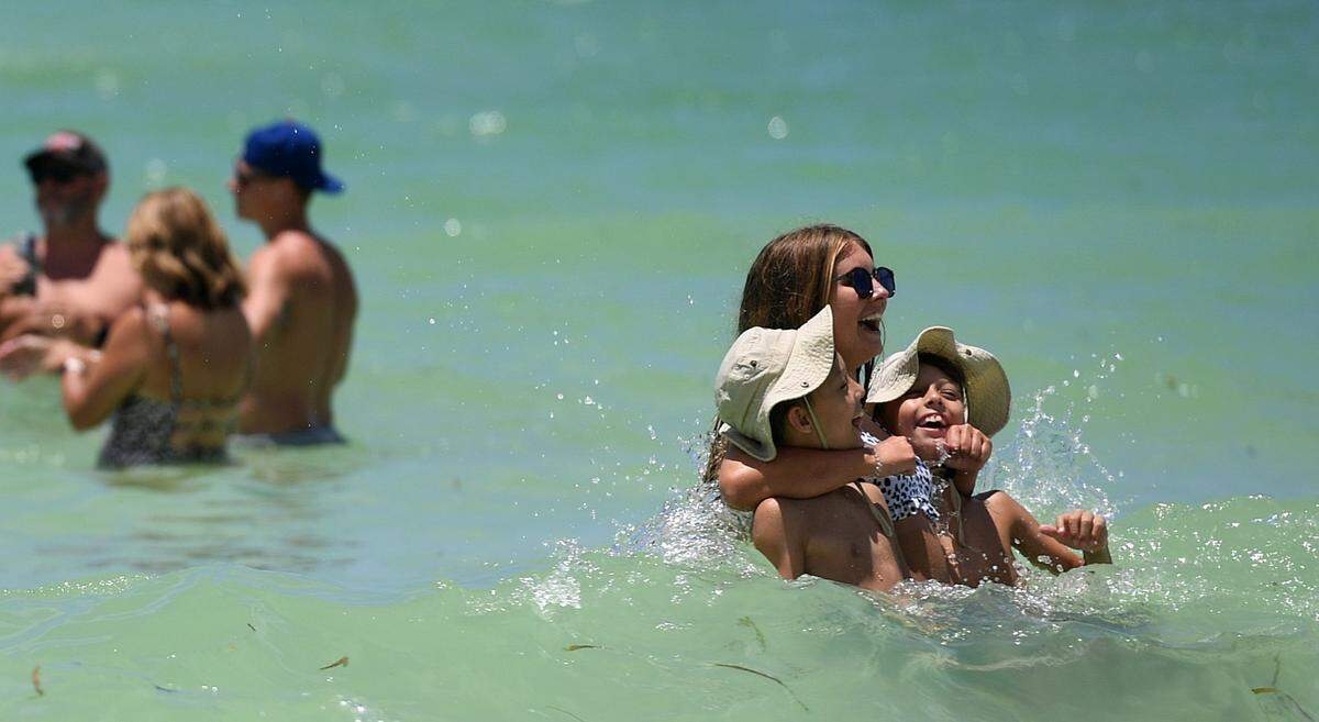 07/21/21-Visitors enjoy the sun and water at Cortez Beach Thursday. As a red tide bloom impacts Anna Maria Island, Manatee County Government staff are monitoring by air, land and sea. Local impacts from the bloom have been mild so far but could get worse.