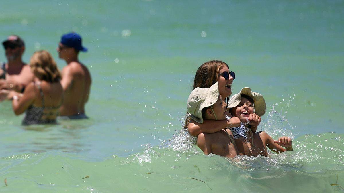 Visitors enjoy the sun and water at Cortez Beach in 2021.
