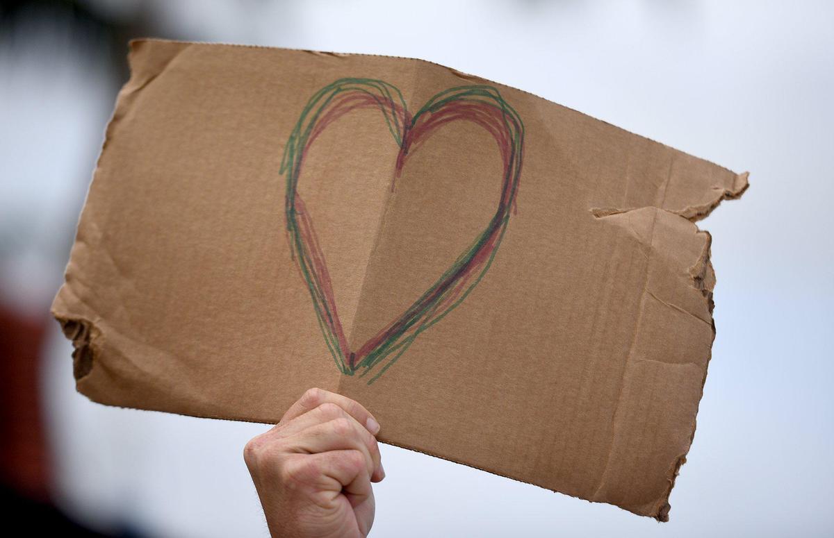 A protester raised a sign during One Love, One Nation, One Heart, as they marched for justice in remembrance of George Floyd. The group of about 200 made their way from Bradenton to Palmetto where they had speeches for racial justice and music.
