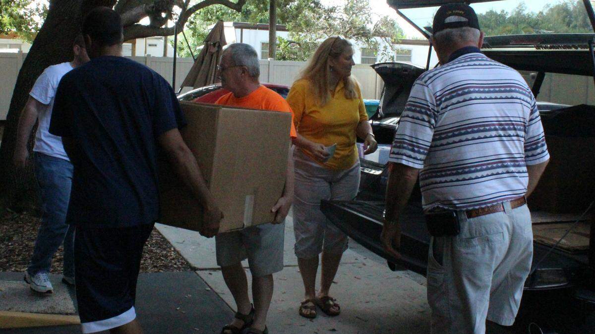 Members of the Ellenton-Parrish Lions Club unload holiday gifts for Manatee Veterans Village on Tuesday. 
 JAMES A. JONES JR./Bradenton Herald