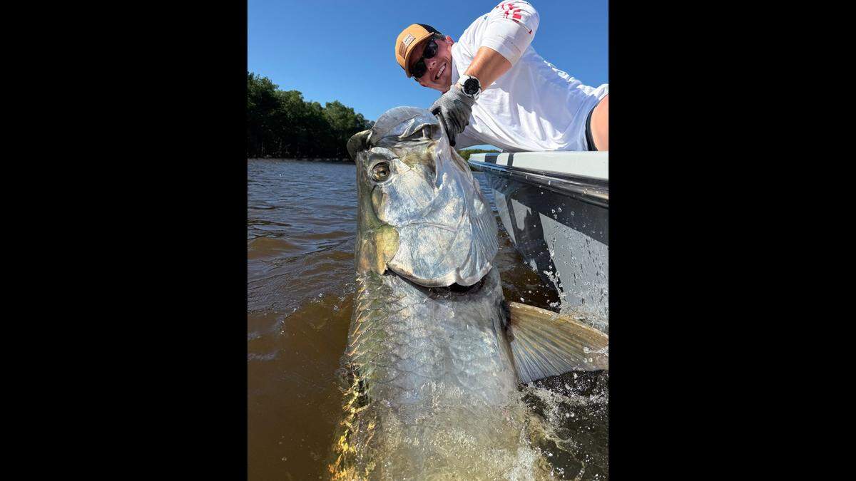 Michael Andrews poses with a 92-inch tarpon that captain Logan Waidelich helped catch on artificial lures in 2025.