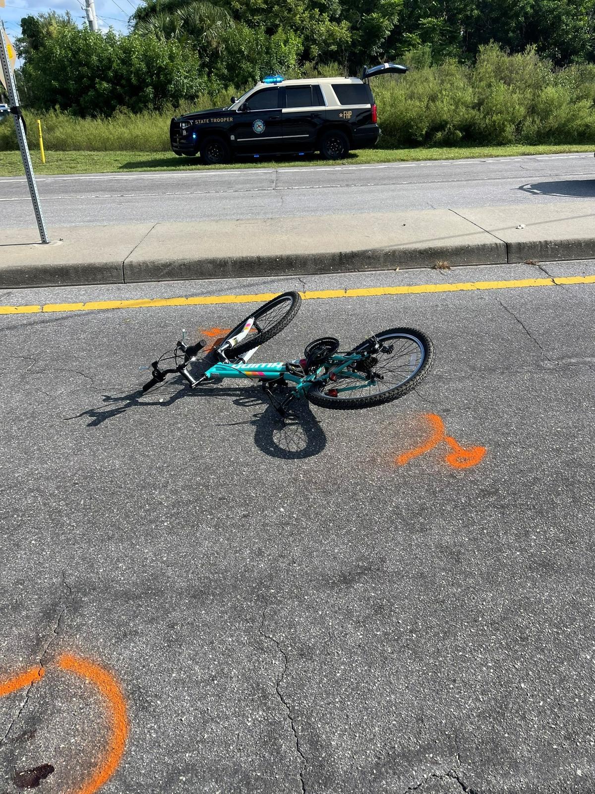 A 13-year-old girl on a bicycle was critically injured in a hit and run on Tuesday, Aug. 16, 2022 and the orange crime scene markings are shown.