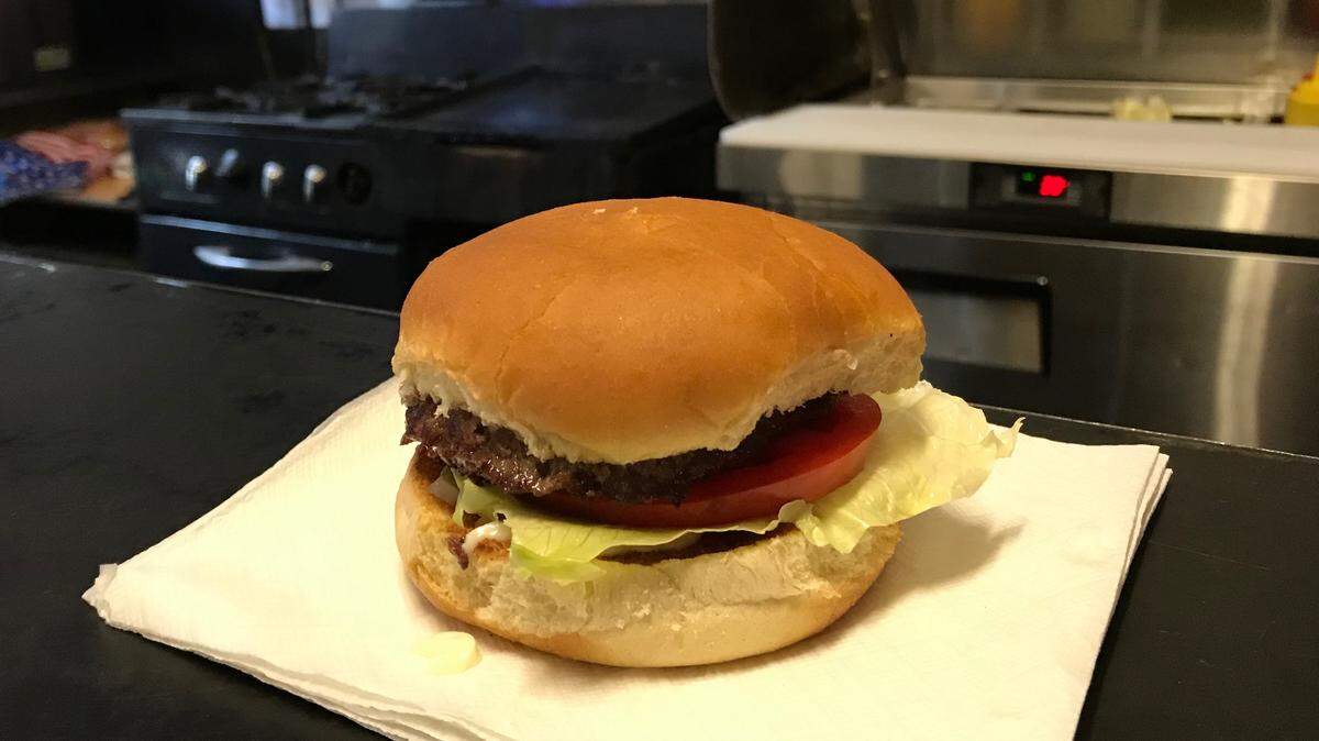 The classic Council’s hamburger is served on a napkin, without French fries.
