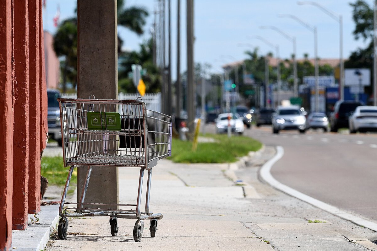 Shopping carts sit randomly on the sidewalks on 14th Street West.
